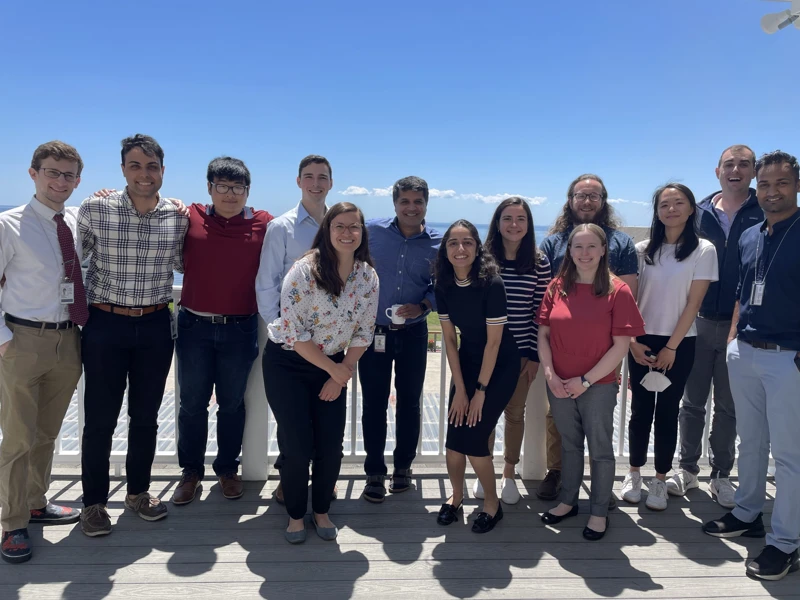 The Bindra Lab posing with a beach in the background.
